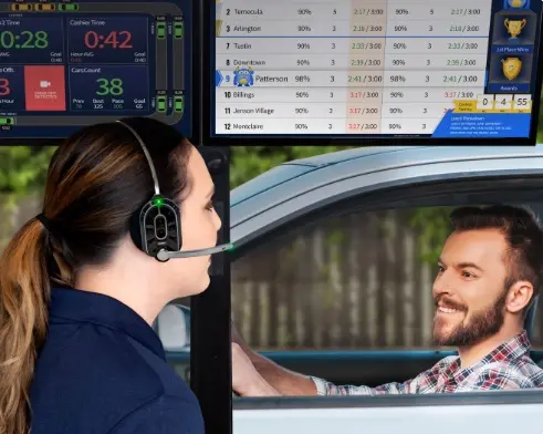 image A woman wearing headphones and sitting in front of a screen.