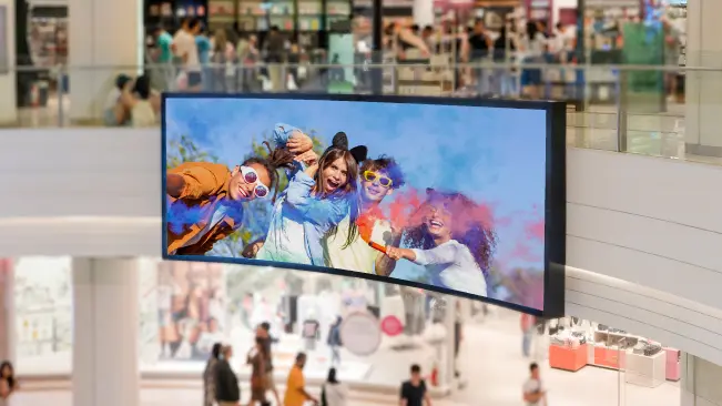 Engage and convert customers with HD visuals A large screen television with people in the background.