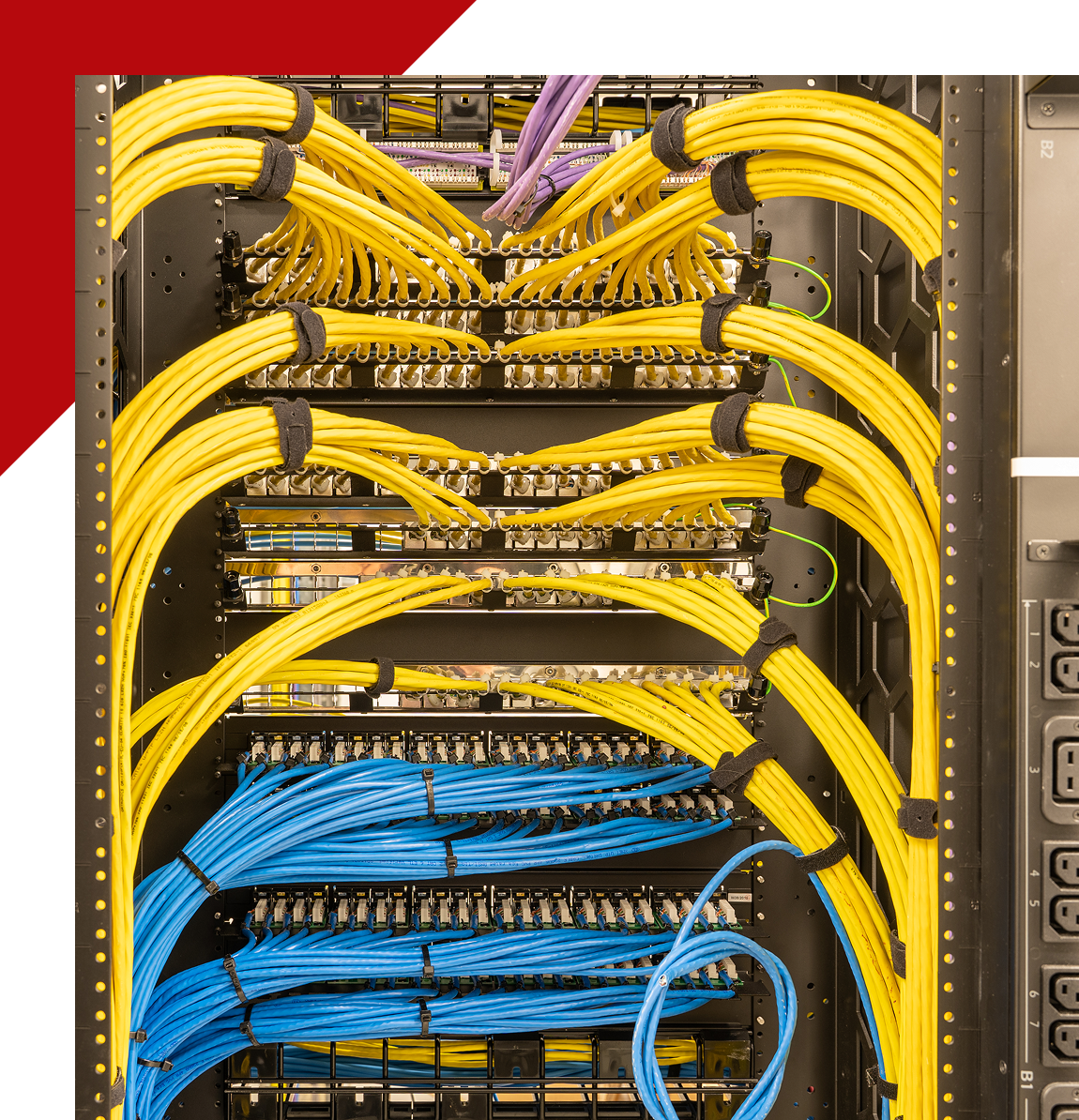 Group 13 A bunch of wires are connected to the back of a rack.