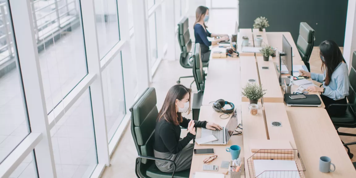 FL-WB-office-featured-2880x1440 Two women sitting at a desk with laptops.