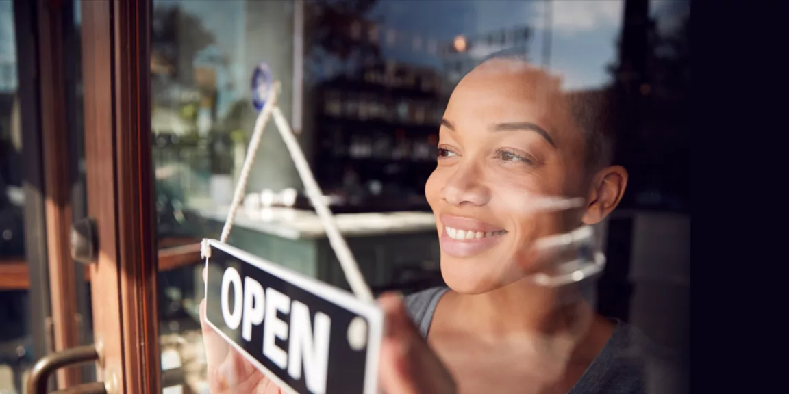 FL-WB-retail-featured-2880x1440 A woman holding an open sign in front of her face.