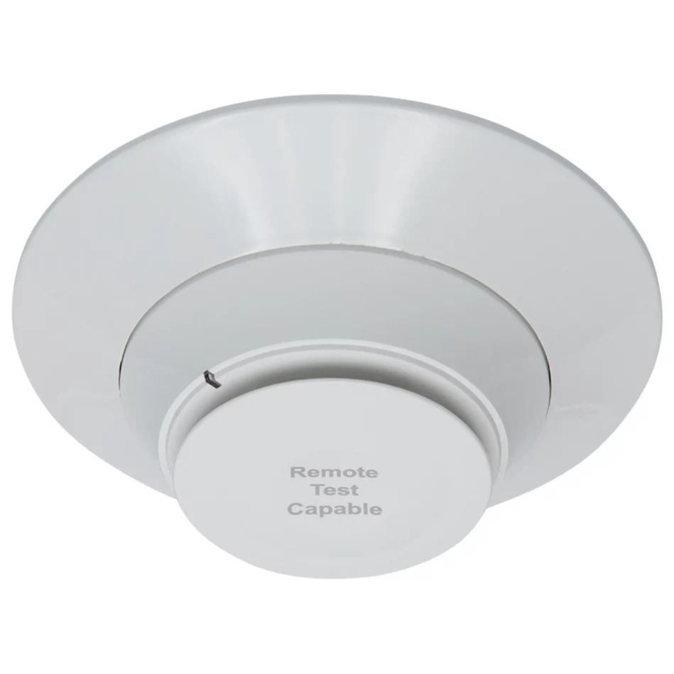 A smoke detector is shown with the words " warning tent compliance ".