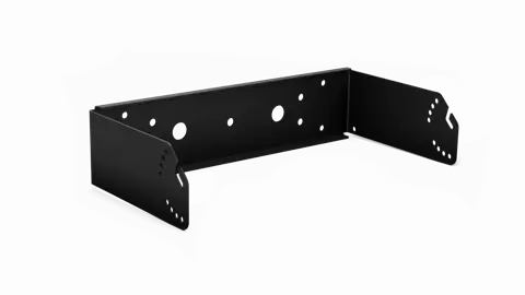 A black metal shelf with holes in it.