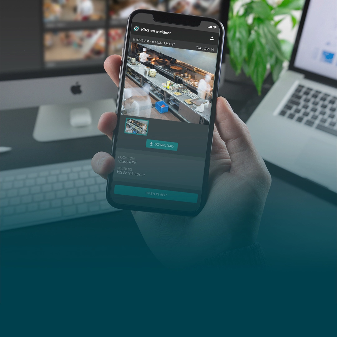 restaurant-save-and-share A person holding an iphone in front of a laptop.