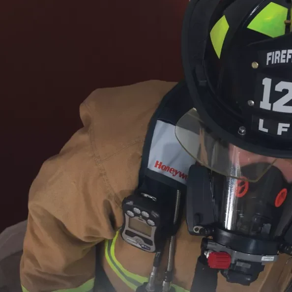 A firefighter wearing a helmet and gloves.